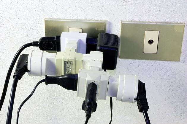 Multiple power adapters plugged into each other