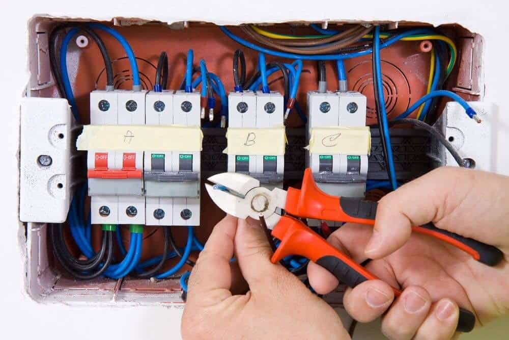Electrical Switchboard with hand holding Wirecutters
